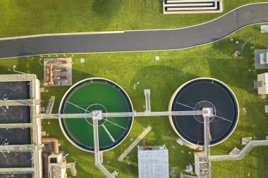 Aerial view of modern water cleaning facility at urban wastewater treatment plant. Purification process of removing undesirable chemicals, suspended solids and gases from contaminated liquid.