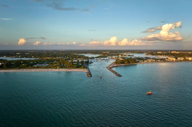 Aerial view of sea shore near Venice, Florida with white yachts at sunset floating on sea waves. North and South Jetty on Nokomis beach. Motor boat recreation on ocean surface. clipart