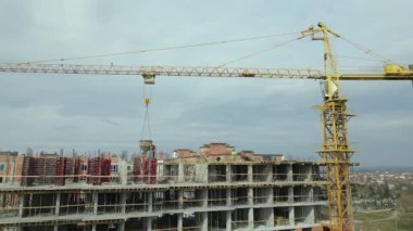 Tower cranes and frame structure of high residential apartment buildings at construction site. Real estate development.