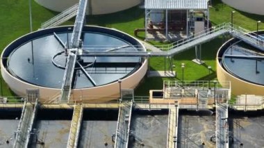 Aerial view of modern water cleaning facility at urban wastewater treatment plant. Purification process of removing undesirable chemicals, suspended solids and gases from contaminated liquid.