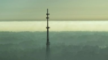 Aerial view of telecommunications cell phone tower with wireless communication 5g antennas for network signal transmission.
