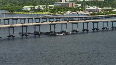 Aerial view of Barron Collier Bridge and Gilchrist Bridge in Florida with moving traffic. Transportation infrastructure in Charlotte County connecting Punta Gorda and Port Charlotte over Peace River.
