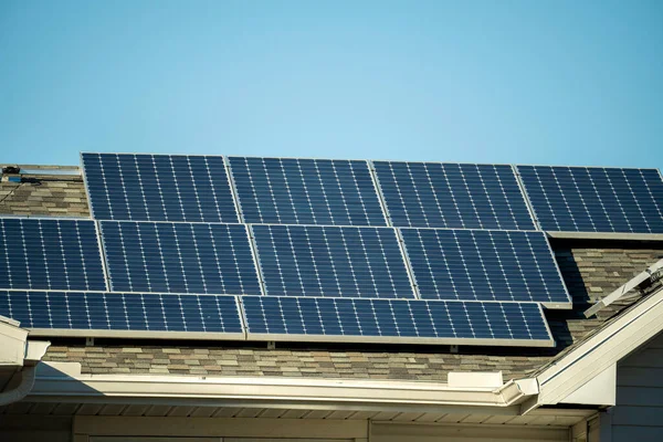 stock image Aerial view of regular american home roof with blue solar photovoltaic panels for producing clean ecological electric energy. Renewable electricity with zero emission concept.