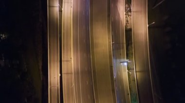 Aerial view of american highway junction at night with fast driving vehicles in Tampa, Florida. View from above of USA transportation infrastructure.