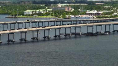 Aerial view of Barron Collier Bridge and Gilchrist Bridge in Florida with moving traffic. Transportation infrastructure in Charlotte County connecting Punta Gorda and Port Charlotte over Peace River.