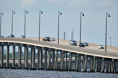Barron Collier Bridge and Gilchrist Bridge in Florida with moving traffic. Transportation infrastructure in Charlotte County connecting Punta Gorda and Port Charlotte over Peace River.