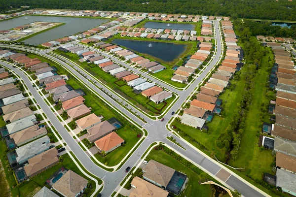 Aerial view of tightly located family houses in Florida closed suburban area. Real estate development in american suburbs.