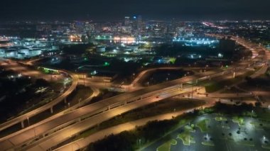 Aerial view of american highway junction at night with fast driving vehicles in Tampa, Florida. View from above of USA transportation infrastructure.