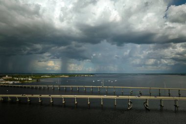 Barron Collier Bridge and Gilchrist Bridge in Florida with moving traffic. Transportation infrastructure in Charlotte County connecting Punta Gorda and Port Charlotte over Peace River.