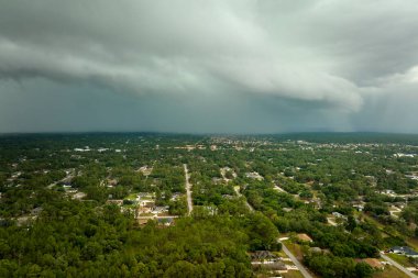Kasaba üzerinde sağanak fırtınadan önce fırtınalı gökyüzünde oluşan kara uğursuz bulutların manzarası..