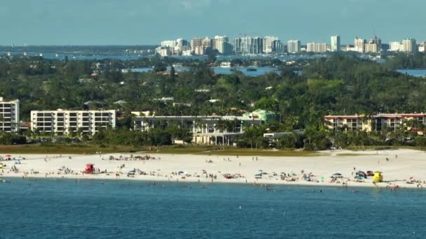 美国萨拉索塔拥挤的Siesta Key海滩高角镜 许多人要求度假时在海水中游泳 并在温暖的佛罗里达阳光下放松 — 图库视频影像