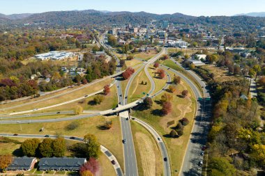 American freeway intersection in Asheville, North Carolina with fast driving cars and trucks in autumnal season. View from above of USA transportation infrastructure.