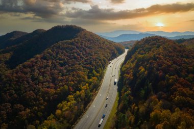 Kuzey Carolina 'da I-40 otobanından Asheville' e giden Golden Fall 'daki Appalachian Dağları' ndan hızla geçen kamyon ve arabalara bakın. Eyaletler arası ulaşım kavramı.