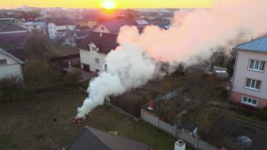Aerial view of agricultural waste bonfires from dry grass and straw stubble burning with thick smoke polluting air causing global warming and carcinogen fumes.