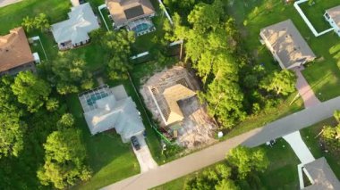 Aerial view of suburban private house wit wooden roof frame under construction in Florida quiet rural area.