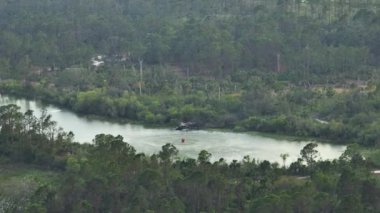 Florida orman ormanlarında şiddetli yangın söndürmek için gölden su dolduran acil servis helikopteri. Polis helikopteri ormanda yangın çıkarmaya çalışıyor..
