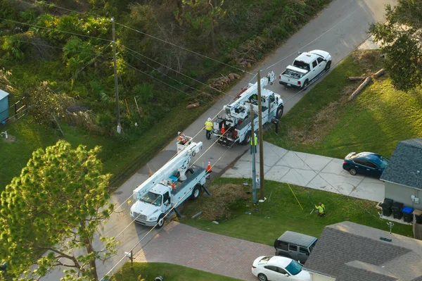 stock image Electrical service company restoring power repairing damaged power lines after hurricane Ian in Florida suburban area.