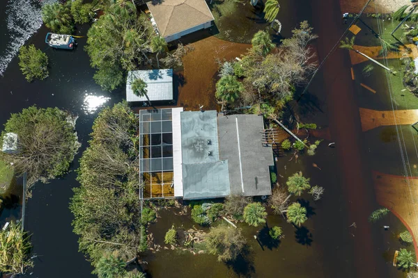 stock image Heavy flood with high water surrounding residential houses after hurricane Ian rainfall in Florida residential area. Consequences of natural disaster.