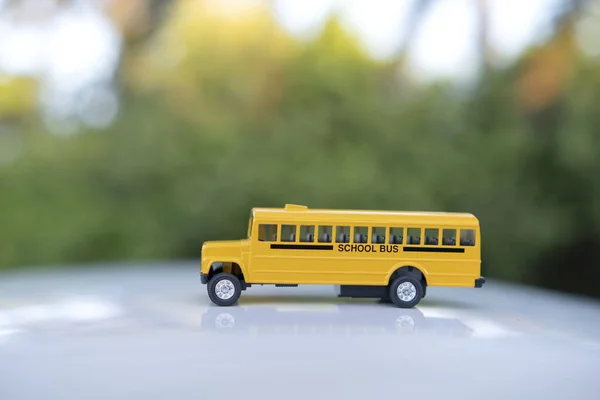 Toy american yellow school bus as symbol of education in the USA.