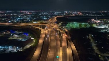 Aerial view of american highway junction at night with fast driving vehicles in Tampa, Florida. View from above of USA transportation infrastructure.
