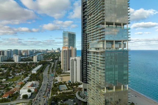 stock image Sunny Isles Beach city with luxurious highrise hotels and condo buildings and busy ocean drive on Atlantic coast. American tourism infrastructure in southern Florida.