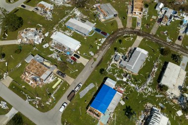 Aerial view of natural disaster consequences in Florida Southwest region. Severely damaged by hurricane Ian mobile homes in residential area. clipart
