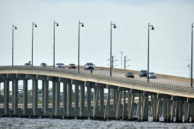 Barron Collier Bridge and Gilchrist Bridge in Florida with moving traffic. Transportation infrastructure in Charlotte County connecting Punta Gorda and Port Charlotte over Peace River.