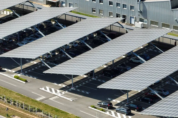 stock image Aerial view of solar panels installed over parking lot with parked cars for effective generation of clean energy.