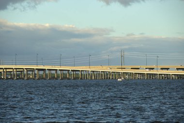 Barron Collier Bridge and Gilchrist Bridge in Florida with moving traffic. Transportation infrastructure in Charlotte County connecting Punta Gorda and Port Charlotte over Peace River.
