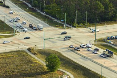 Trafik ışıklarıyla kesişen geniş yol manzaralı. ABD 'de şehir ulaşımı. Amerikan şehir trafiği yukarıdan.