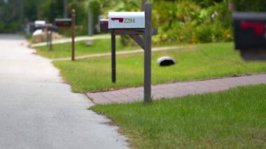 Typical american outdoors mail box on suburban street side.