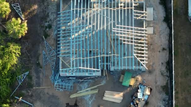 フロリダ郊外の建設中の未完成の家のスチールトラス構造から作られた屋上アセンブリの上からの眺め アメリカの住宅概念の発展 — ストック動画
