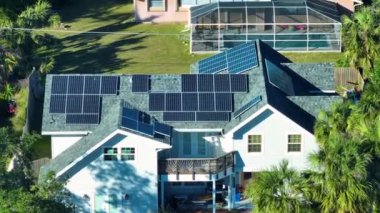 Aerial view of typical american building roof with rows of blue solar photovoltaic panels for producing clean ecological electric energy. Renewable electricity with zero emission concept.