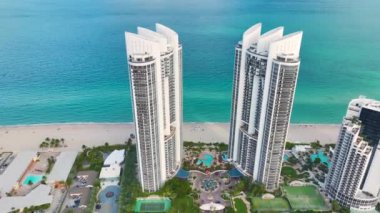 Pahalı otelleri ve Atlantik Okyanusu kıyısındaki apartman binalarıyla Sunny Isles Beach 'in yüksek açılı manzarası. Güney Florida 'daki Amerikan turizm altyapısı.