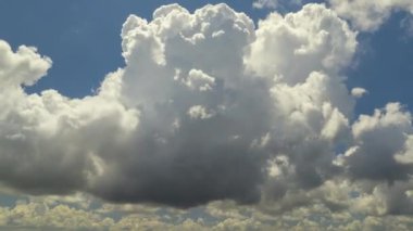 Hareket eden ve değişen bulutlu hava. Yazın mavi gökyüzünde fırtınadan önce beyaz tüylü kümülonimbus bulutları oluşuyor..