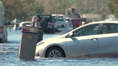 Amerikan caddesini, Florida yerleşim bölgesinde suyla çevrili bir araçla su basmış. Ian kasırgasının doğal afeti..