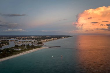 High angle view of crowded Nokomis beach in Sarasota County, USA. Many people enjoing vacations time swimming in ocean water and relaxing on warm Florida sun at sundown.