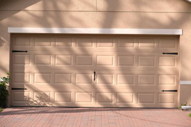 Wide garage double door and concrete driveway of new modern american house. clipart