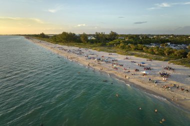 Aerial evening seascape with Nokomis sandy beach in Sarasota County, USA. Many tourists enjoing summer vacation time swimming in warm Mexico gulf water and sunbathing on hot Florida sun. clipart