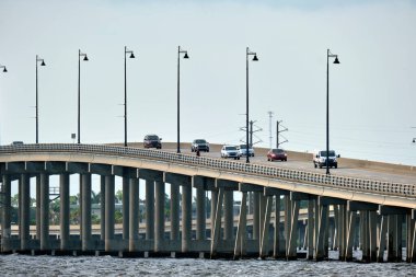 Barron Collier Bridge and Gilchrist Bridge in Florida with moving traffic. Transportation infrastructure in Charlotte County connecting Punta Gorda and Port Charlotte over Peace River.
