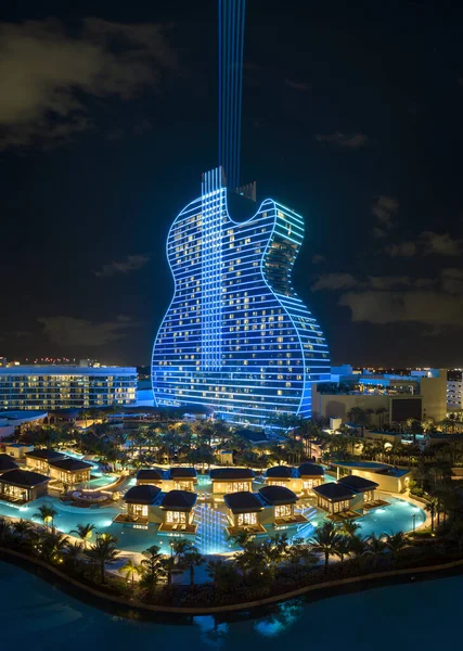 Aerial view of guitar shaped Seminole Hard Rock Hotel and Casino structure illuminated with bright neon colorful lights in Hollywood, Florida.