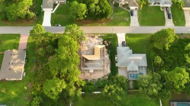Aerial view of residential private home with wooden roofing structure under construction in Florida quiet rural area. Real estate development concept.