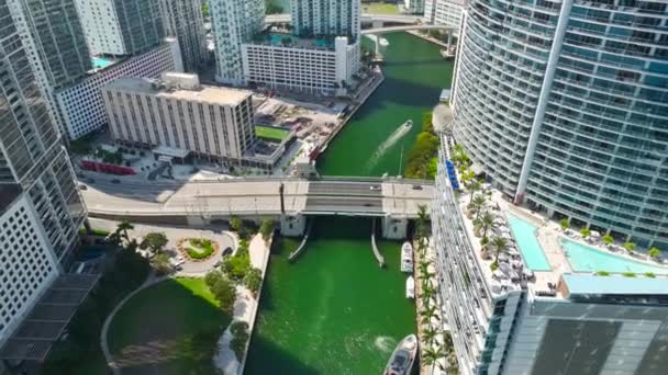 米国フロリダ州マイアミ ブリッケル市のダウンタウン地区にあるマイアミ川を航行する高級ヨット 現代のアメリカのメガポリスにある高層ビルと都市のスカイライン — ストック動画
