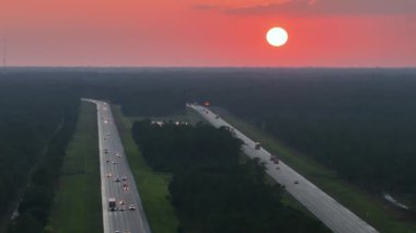 Florida 'daki kalabalık I-75 otobanından gün doğumunda trafiğin hızla ilerlediği manzarayı izleyin. Eyaletler arası hızlı ulaşım kavramı.