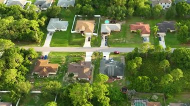 Aerial landscape view of suburban private houses between green palm trees in Florida quiet rural area.