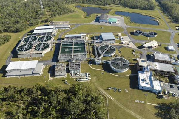 stock image Aerial view of water treatment factory at city wastewater cleaning facility. Purification process of removing undesirable chemicals, suspended solids and gases from contaminated liquid.