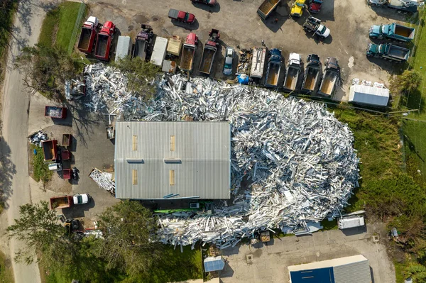 Beg pile of scrap aluminum metal siding from ruined houses after hurricane Ian swept through Florida. Recycle of broken parts of mobile homes.