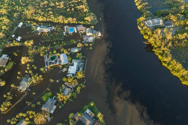 stock image Heavy flood with high water surrounding residential houses after hurricane Ian rainfall in Florida residential area. Consequences of natural disaster.