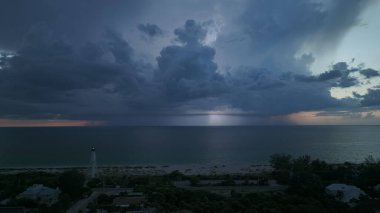 Karanlık evleri ve okyanus kıyısında uzun deniz feneri olan bir sahil kasabası fırtınalı bir gecede gemilerin seyrüsefer için yanıp sönen bir ışık. Deniz üzerinde şimşekler çakan fırtına gemiler için tehlike arz ediyor..