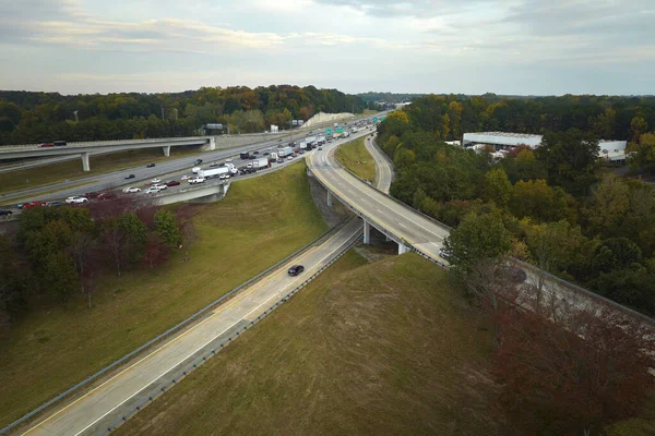 stock image American freeway intersection with fast driving cars and trucks. View from above of USA transportation infrastructure.